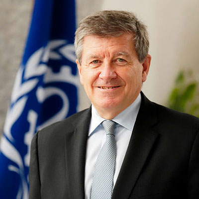 Guy Ryder ILO DG in from of ILO flag