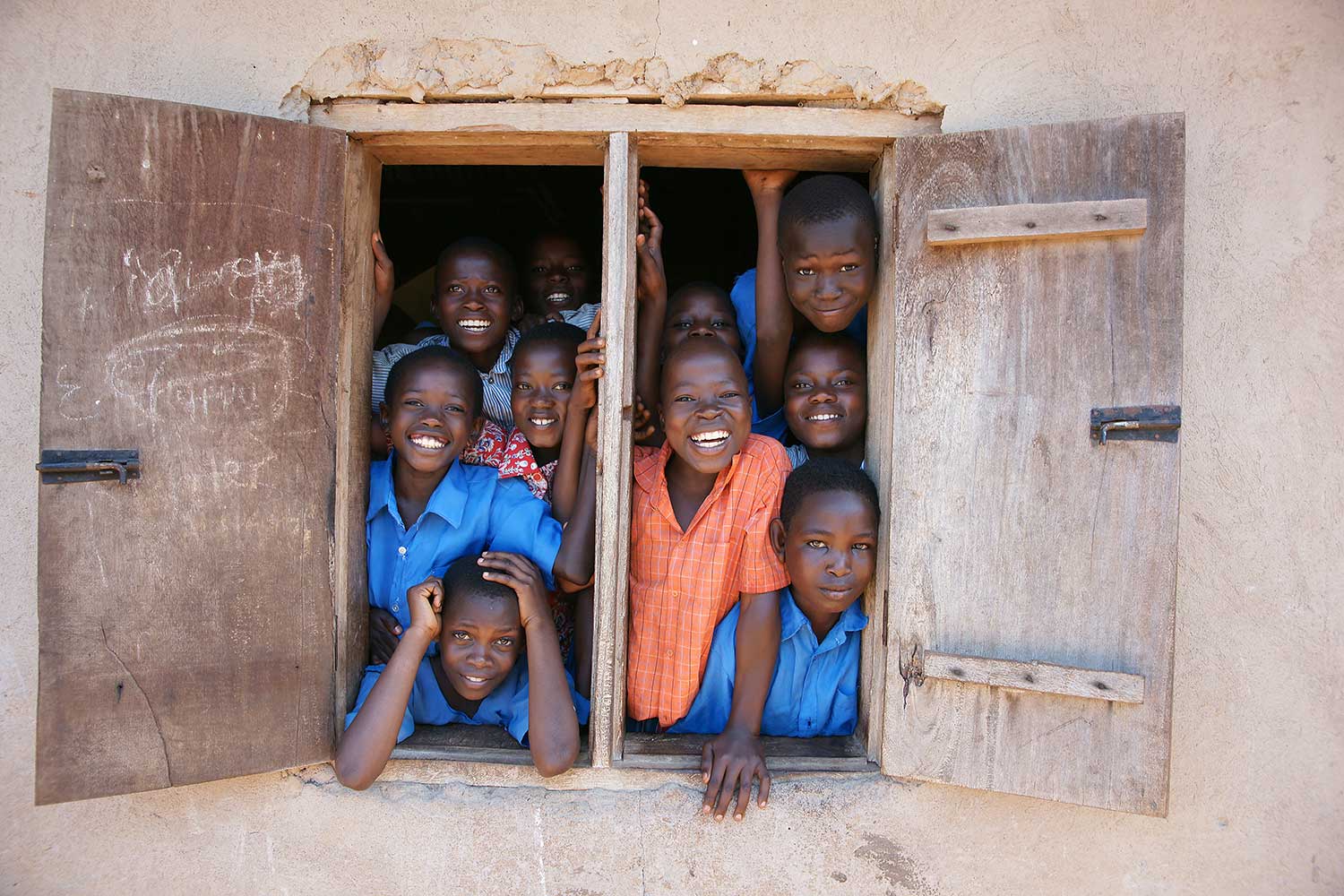 Group of children laughing in a window frame