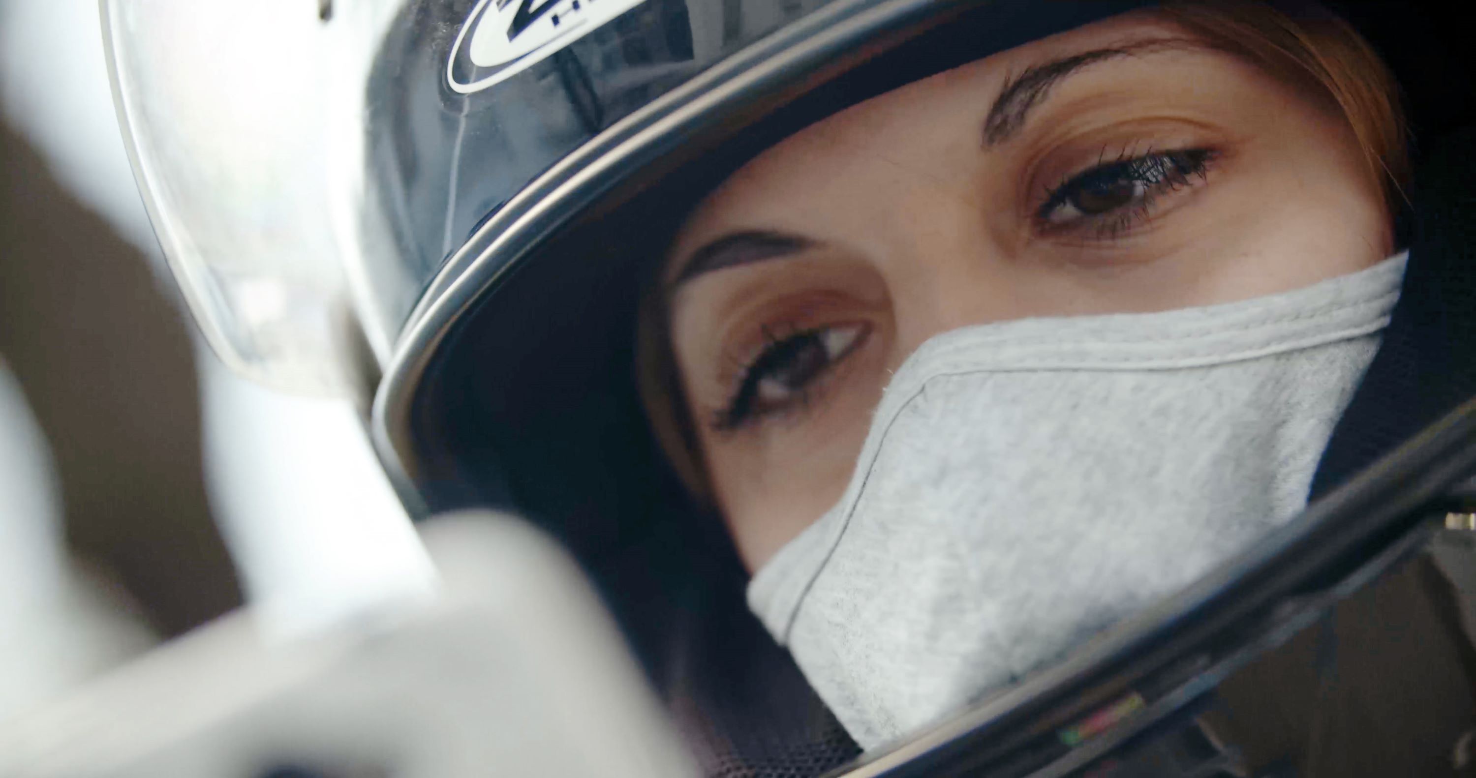 Close up shot of woman with helmet and white protective mask
