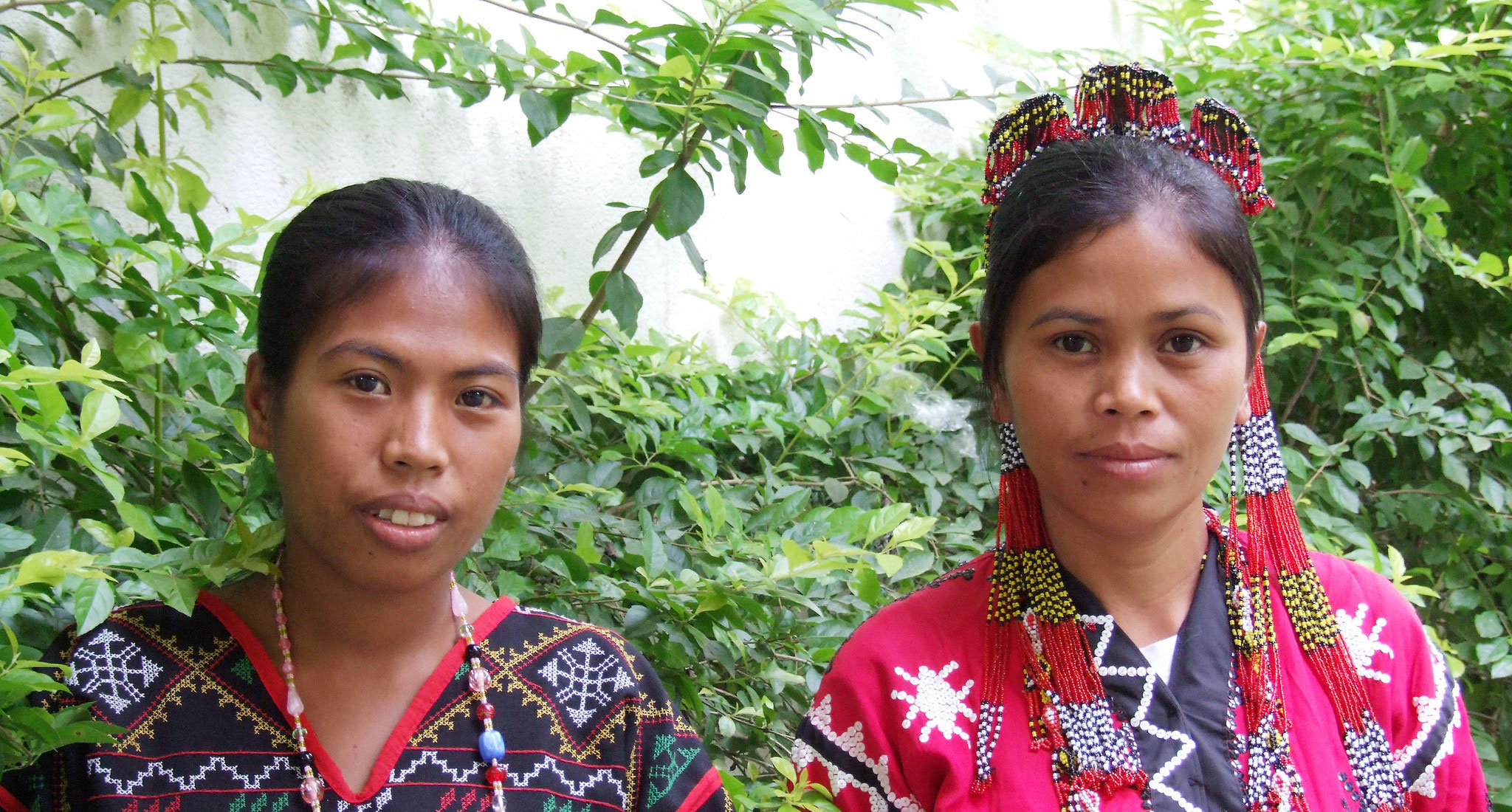 Two indigenous women with bright clothes and jewellery