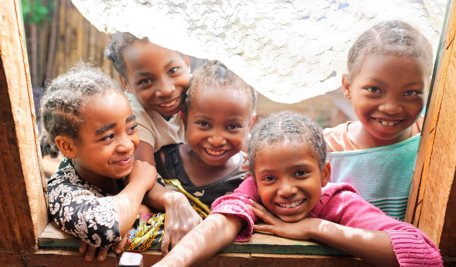 African children smiling in a window frame