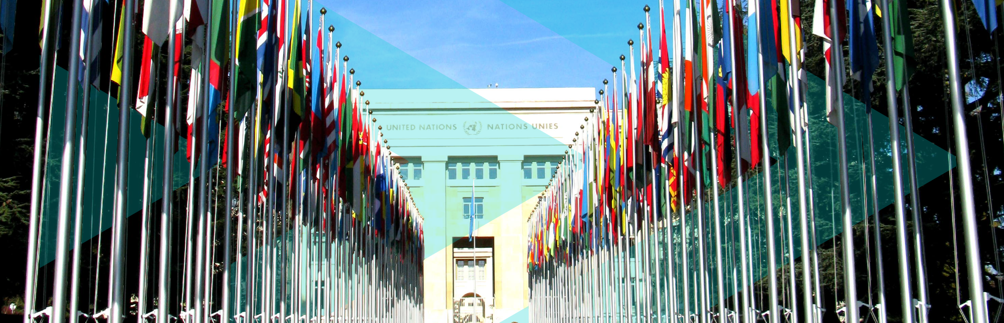 Alley of meber nation flags leading up to UN Building in Geneva, blue skies