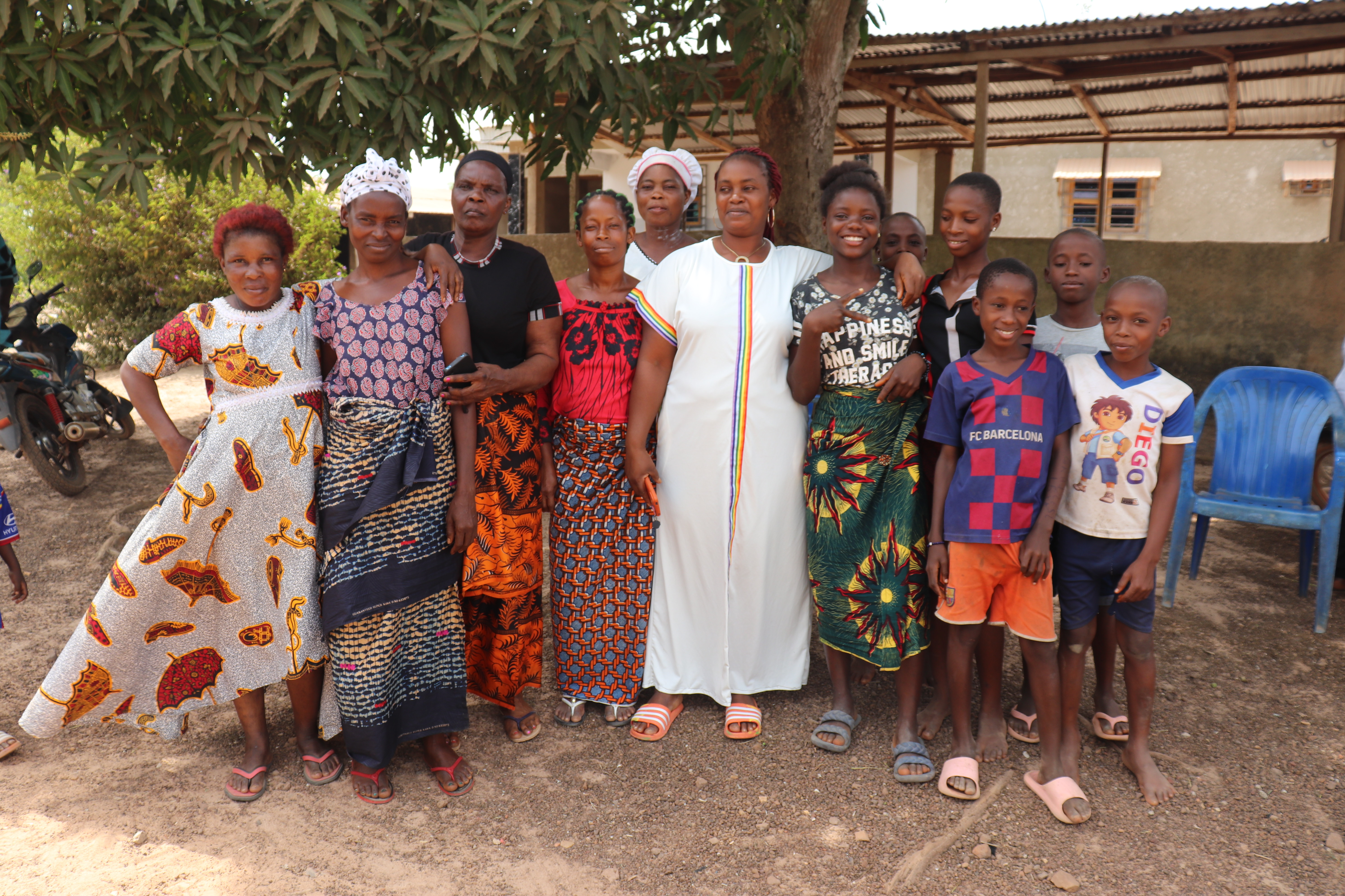 Group of black women and boys smiling together outside