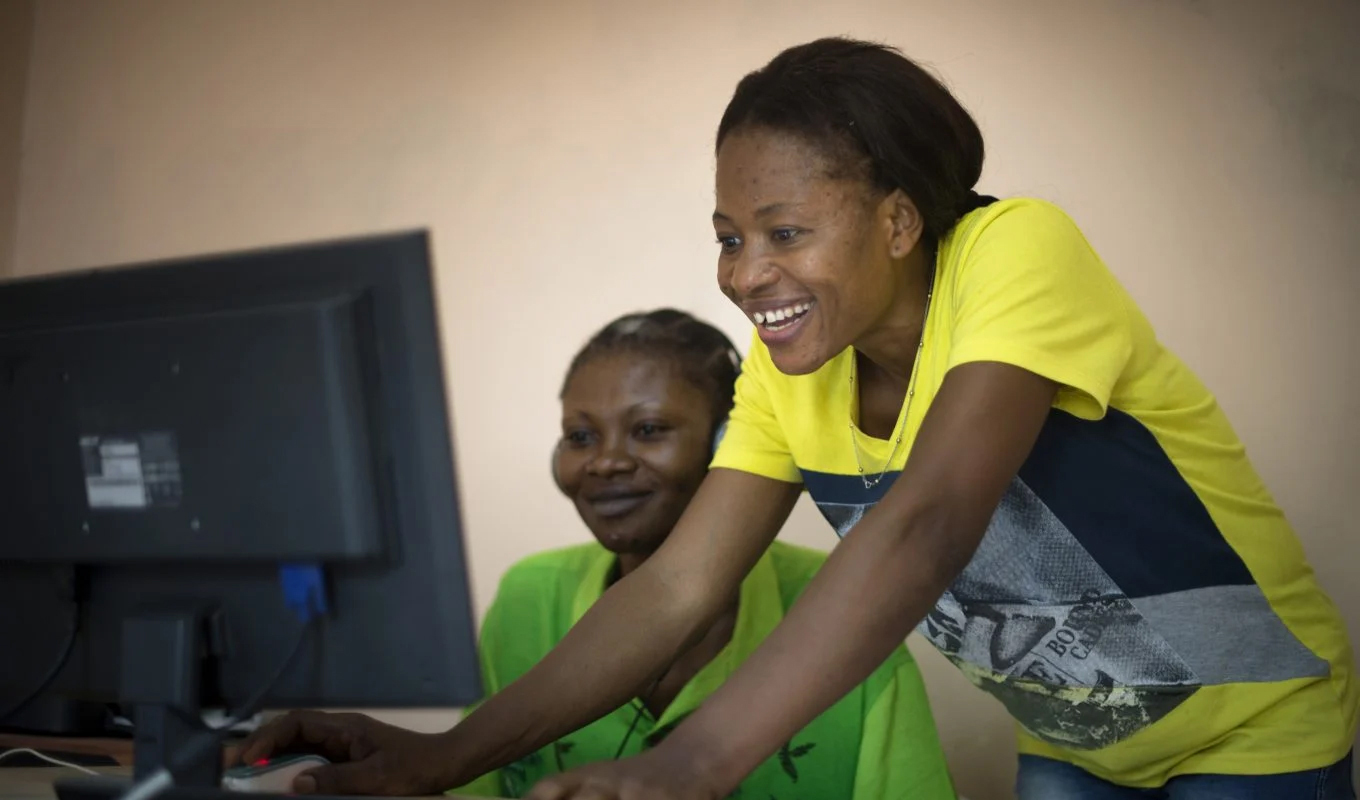 Two young African women working on a computer