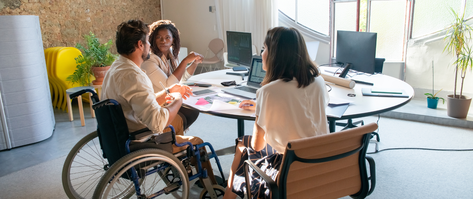 Disabled people meeting around a table