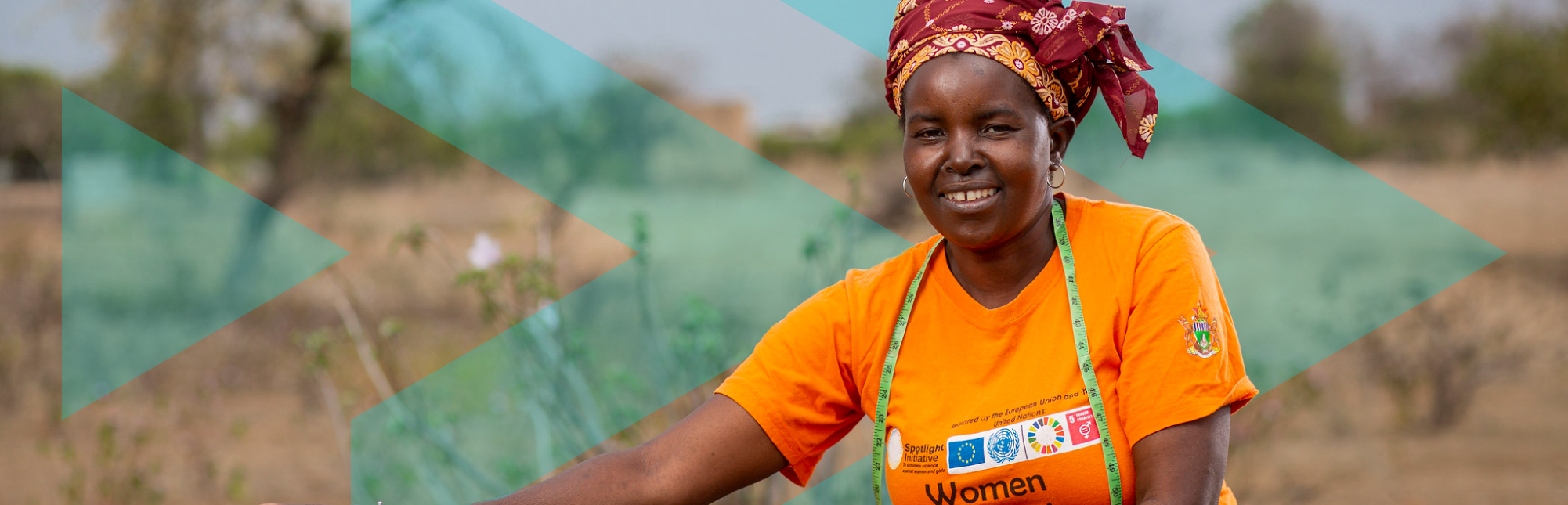 Lady with colourful head scarf sitting with manual sewing machine in field in Machona, Chipinge, Zimbabwe