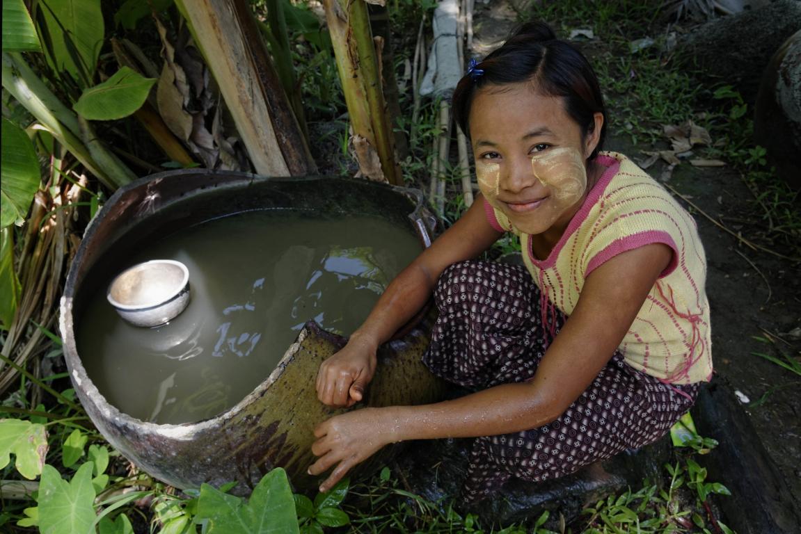 Young girl with her cheeks decorated with yellow "thanaka" paste. Region of Mawlamyaingyun. Myanmar
