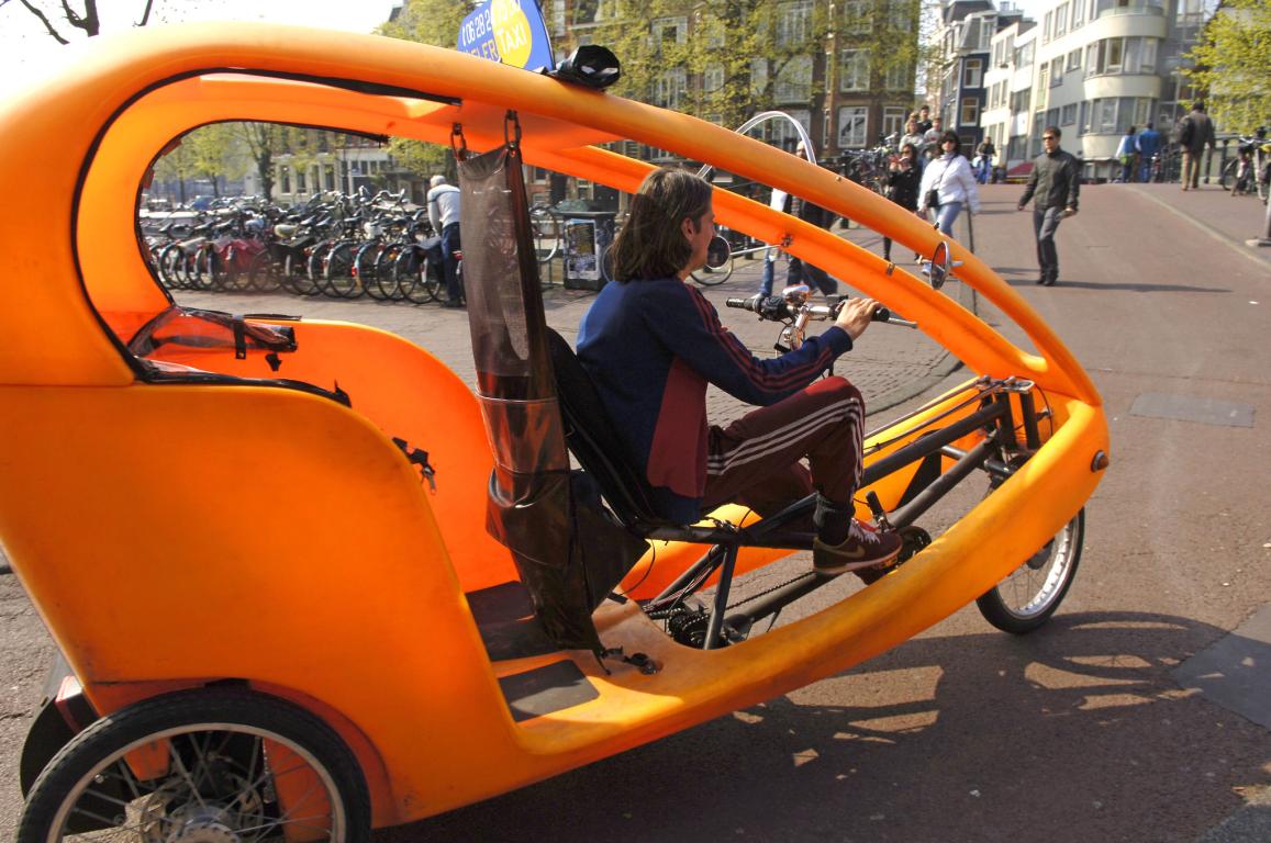 Bicycle-taxi in the streets of Amsterdam. Netherlands. April 2007