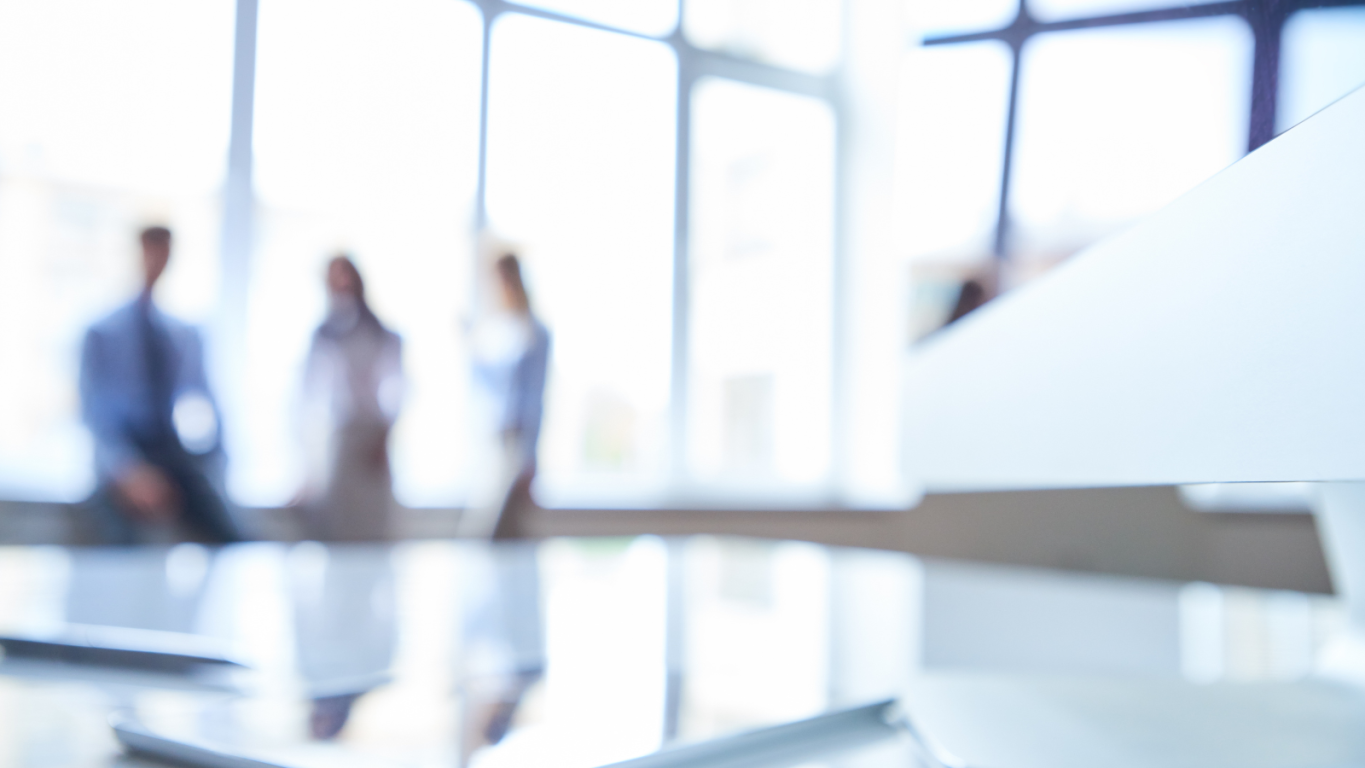 Out of focus image with 3 people standing by window