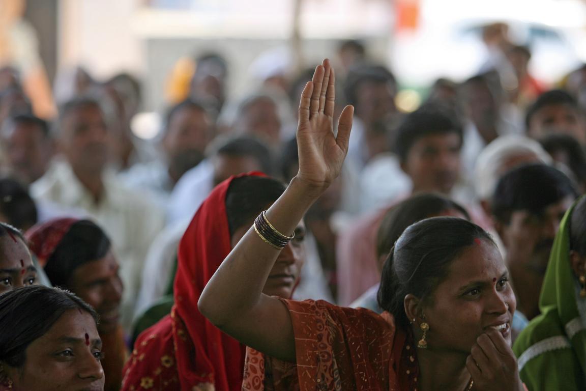 Indian woman raises her hand to speak