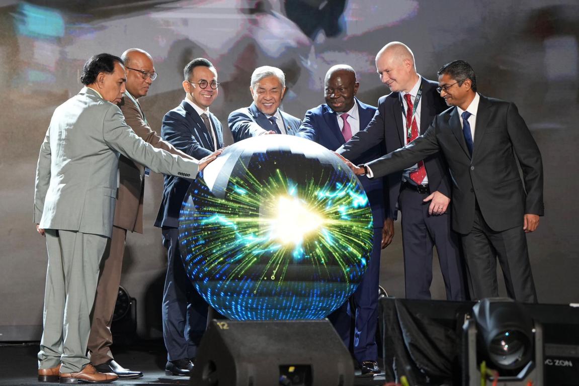 A group of men around a sphere lit