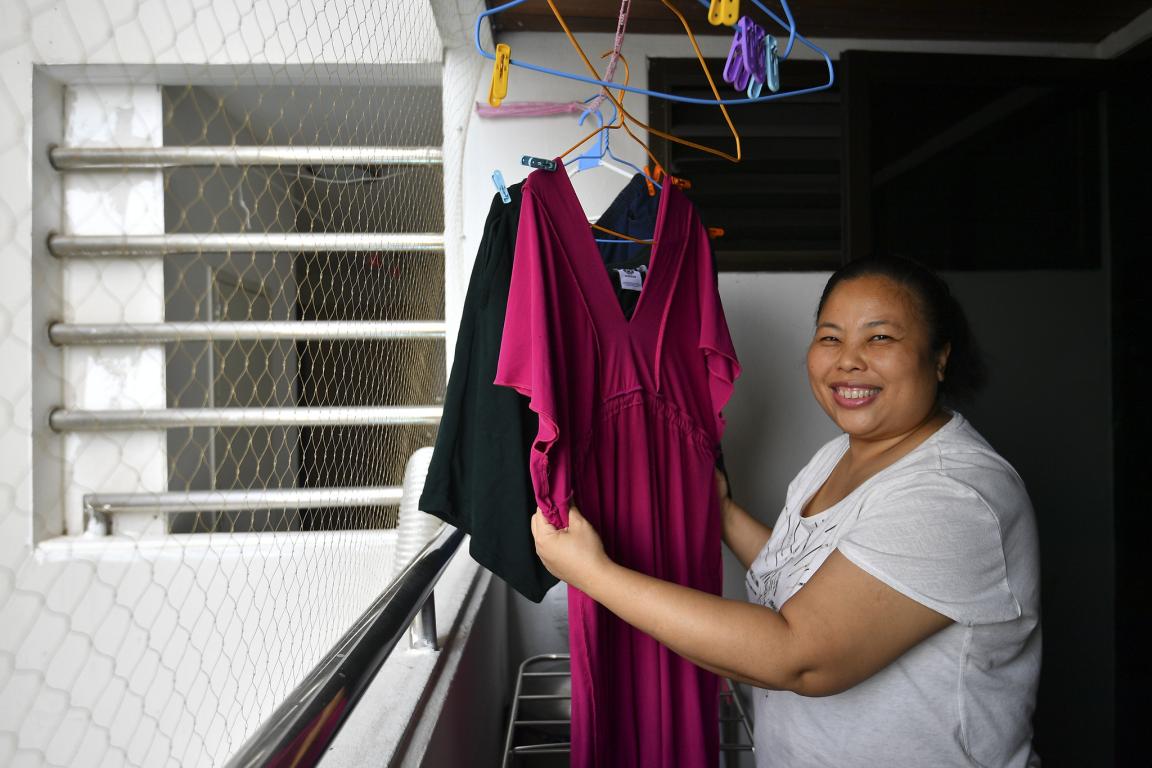Smiling migrant domestic worker in Thailand