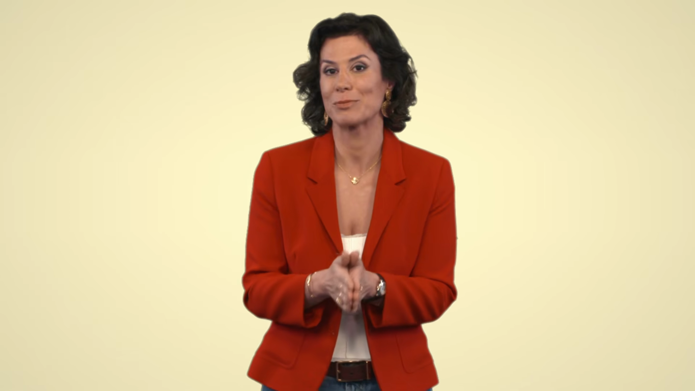 Manal Aziz stands in front of a yellow background