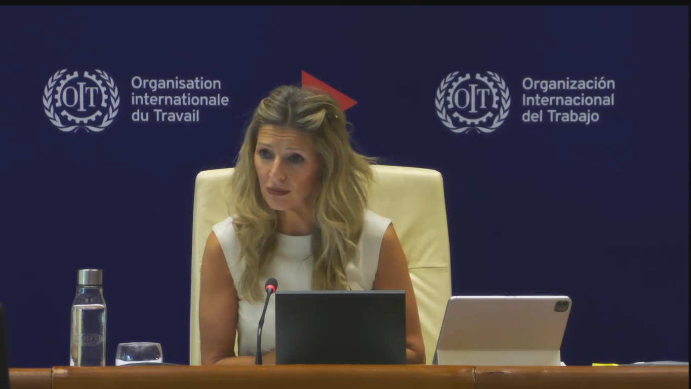 Yolanda Diaz speaks in front of a branded ILO background
