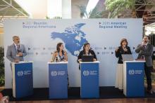 3 ladies and 2 men in a panel discussion standing in front of a banner with 20th ARM written