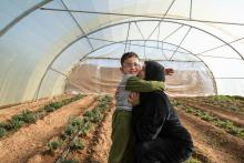 Syrian efugee mother hugging her son in Mafraq, Jordan