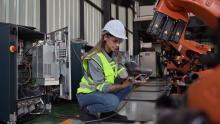 Maintenance engineer worker working with robotic machine at factory 