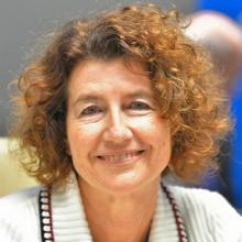 Head shot of a lady with short curly hair smiling - Manuel Tomei, ILO Assistant Director