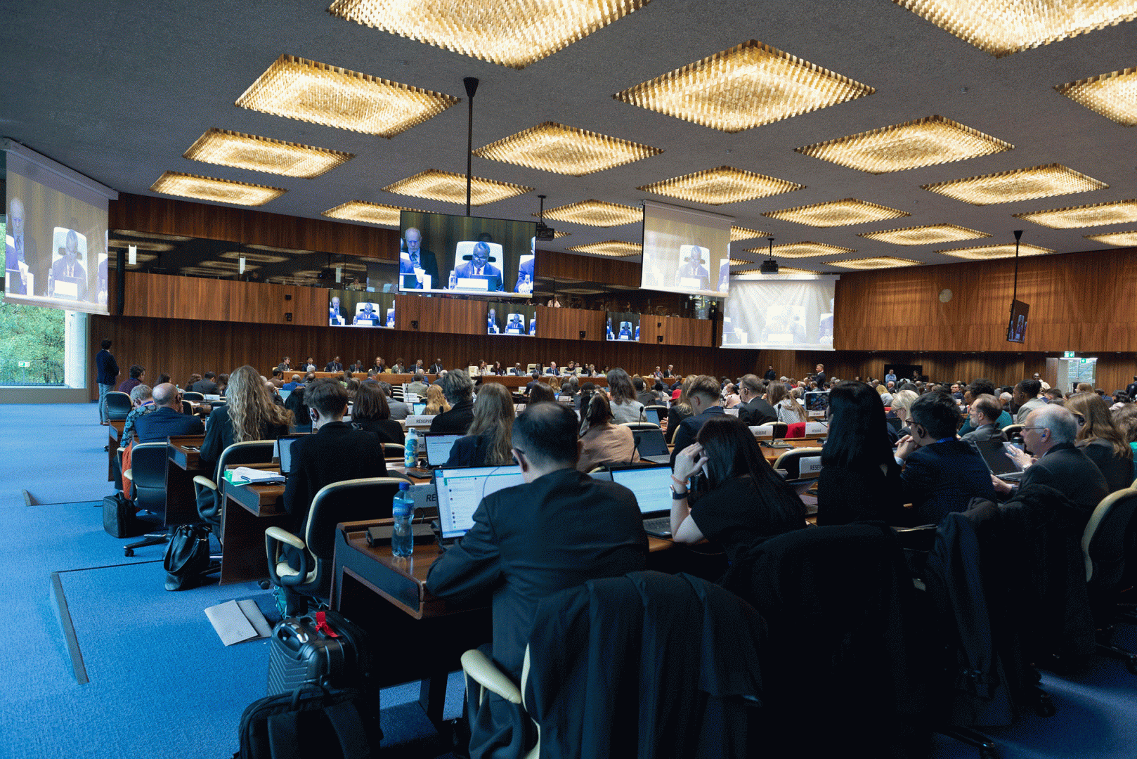 View of governing body meeting room with all participants listening to speaker