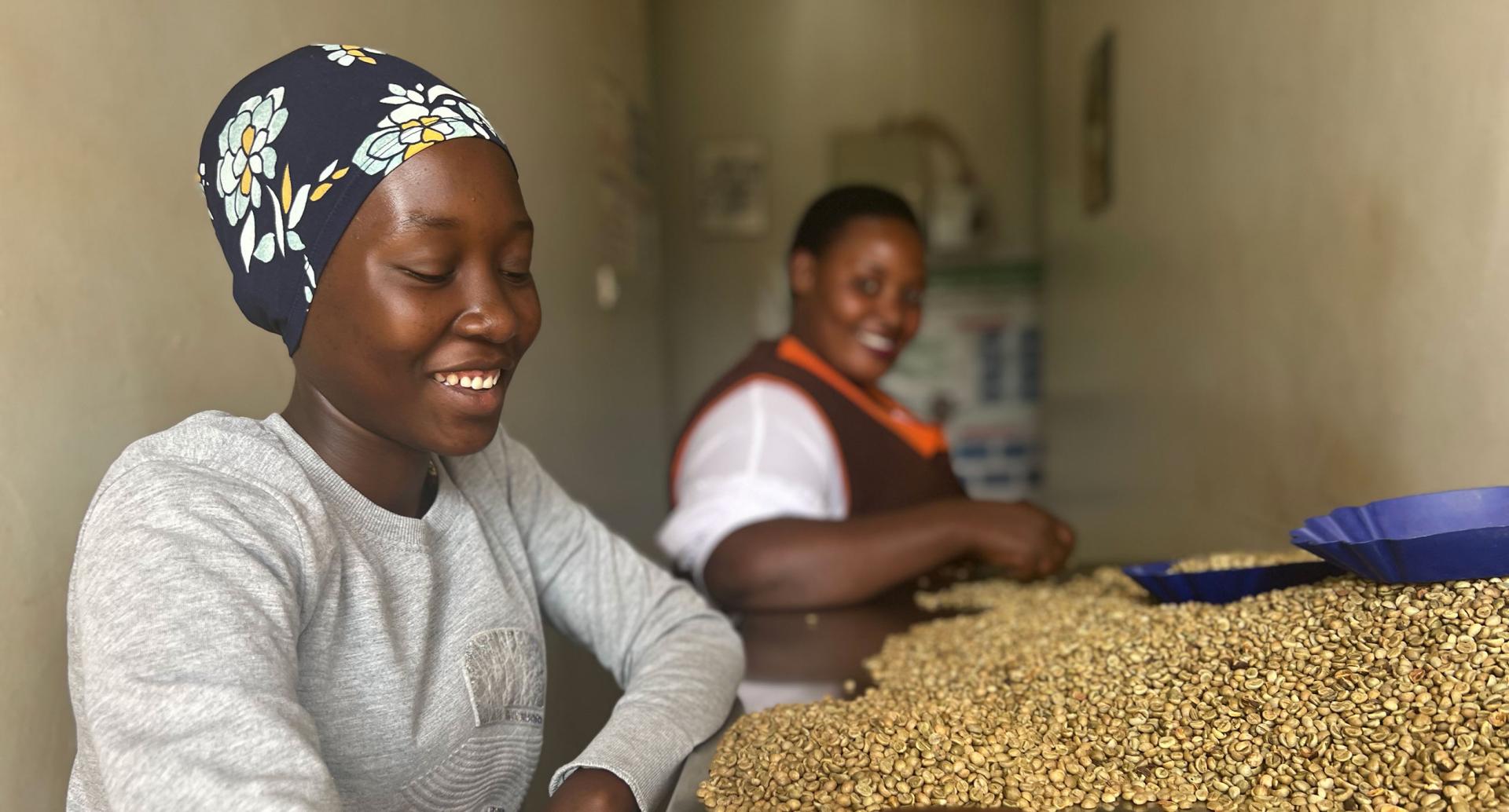 Two Ugandan women working in a coffee supply chain 